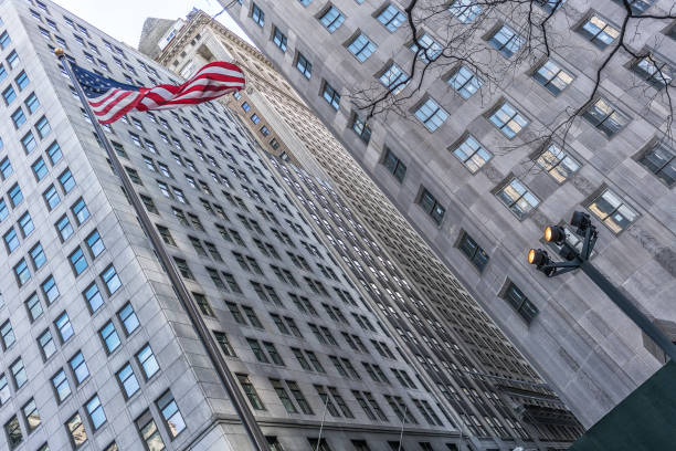 istock American flag with buildings behind. 919014376