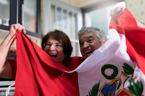istock Peruvian senior couple fan watching soccer game at home 919014664