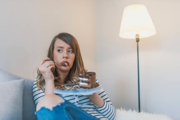 istock Sad unhappy woman eating cake 919018014