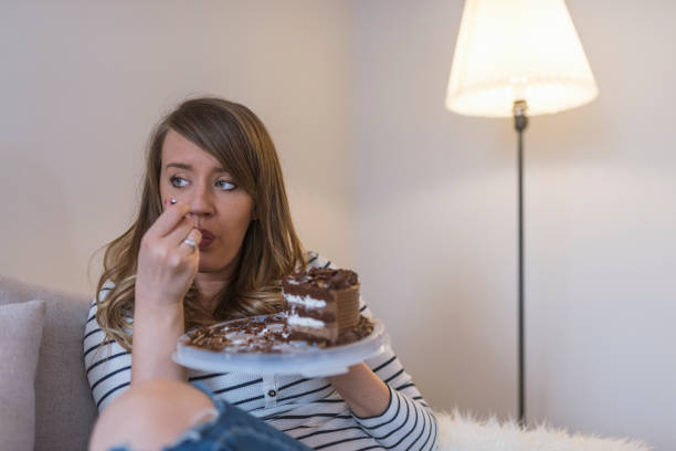 istock Sad woman eating sweet cake 919023072