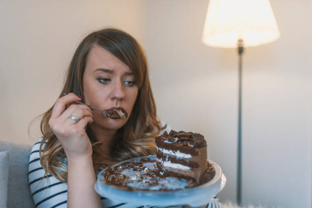 istock Sad woman eating sweet cake 919046336