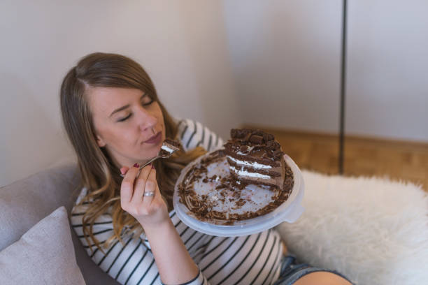 istock Woman eating chocolate cake with spoon 919055040