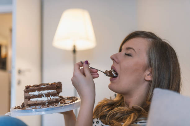 istock Pretty young woman eats a sweet cake 919060626