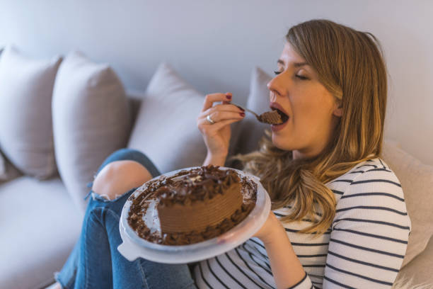 istock Closeup of woman eating chocolate cake 919089922