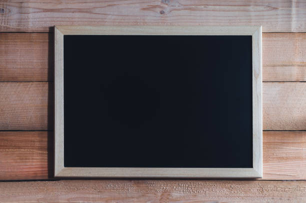 istock blank blackboard on wood table or blackboard hang on wood wall with copy space for text design. 919101134
