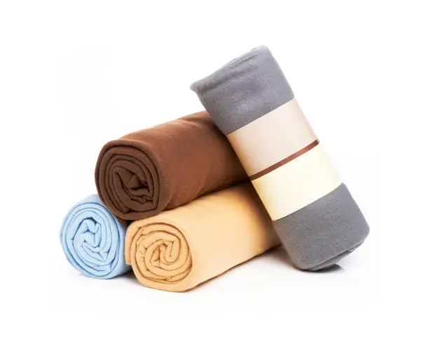 Photo of stacked & rolled new fleece blankets