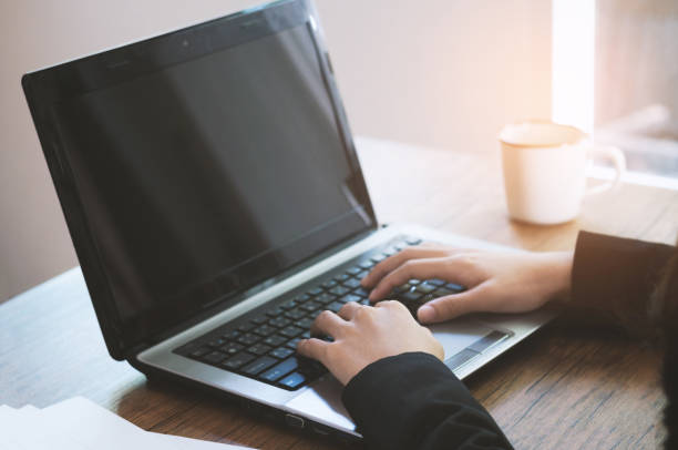 istock business woman working on laptop and using smartphone in office with graph work sheet. 919105190