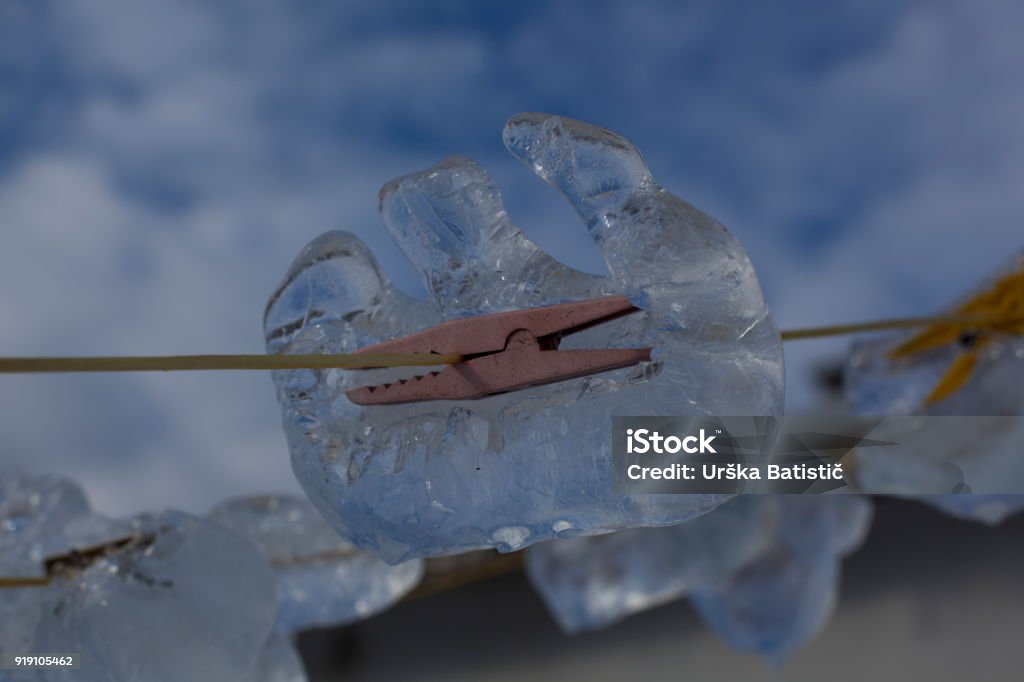 Frozen clippers Clothes pegs forgotten in ice. Advice Stock Photo