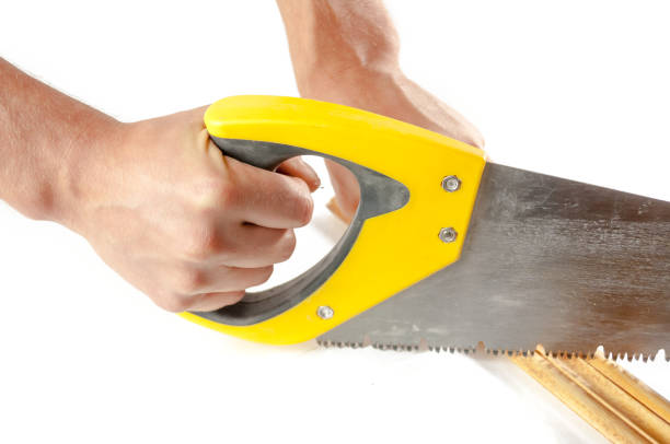 istock Men's hands cut saw wooden plinth 919111834