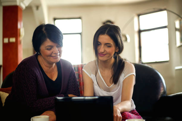 istock Mother and daughter looking at laptop together 919123556