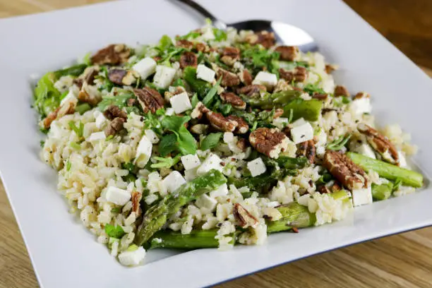Asparagus salad with brown rice, feta cheese and lemon