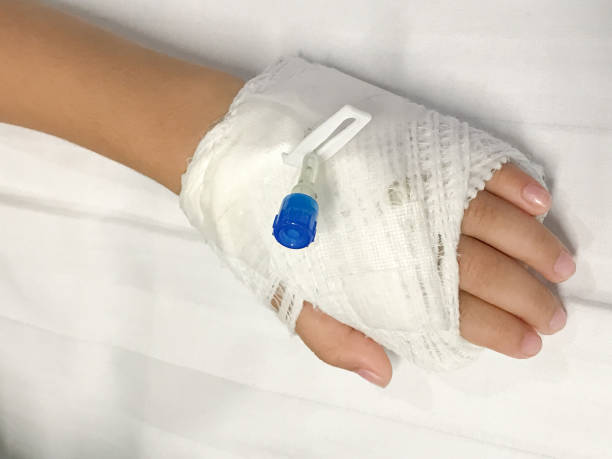 istock Close up of iv plug in baby hand for saline solution 919151098