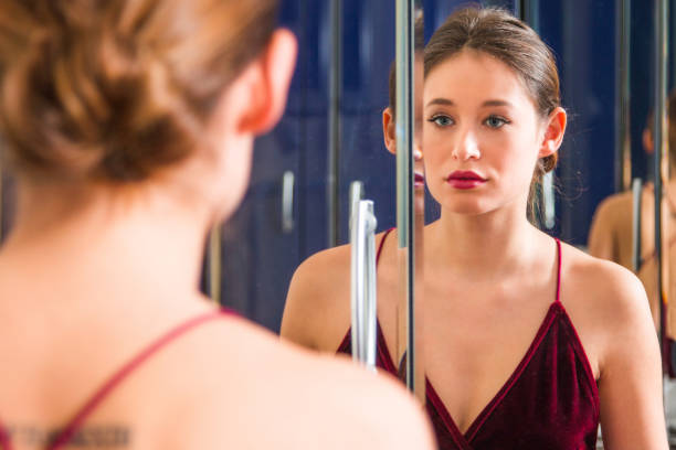 istock Beautiful young woman in front of the mirror 919155018