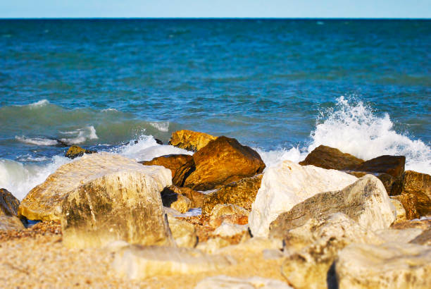istock white rocks hit by large foamy waves 919171778