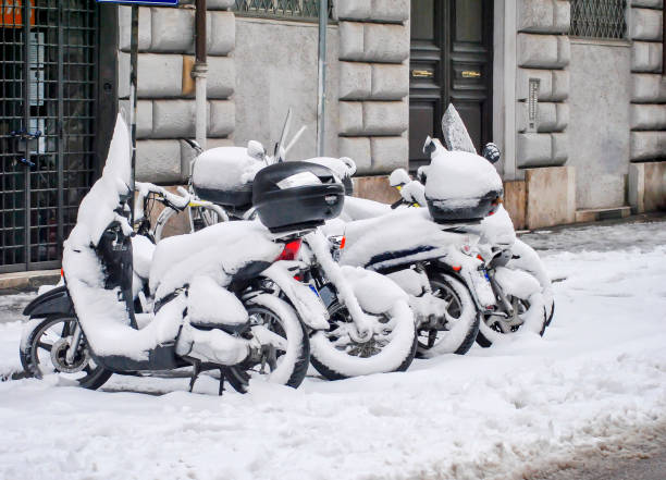 a group of snow-covered scooters