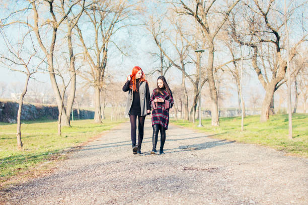 istock Two young girls walking in park. 919176072