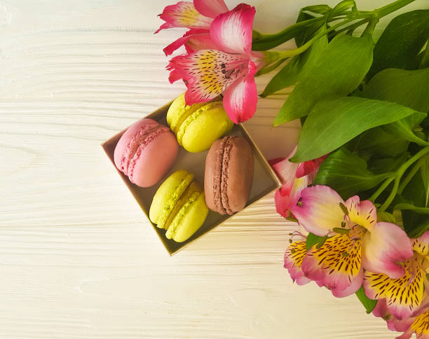 istock macaron in a box on a white wooden background, alstroemeria flowe 919176138