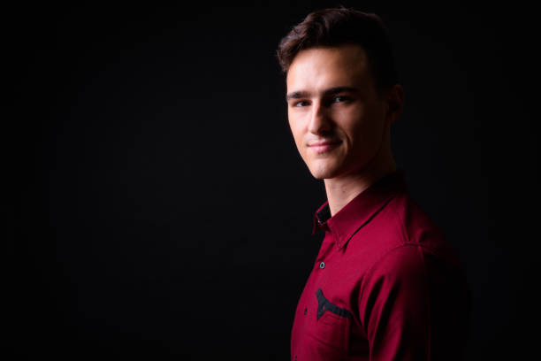 istock Portrait Of Handsome Man Against Black Background 919176392