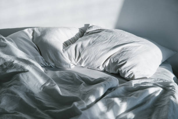 istock crumpled bed on sunrise sun lights 919181088