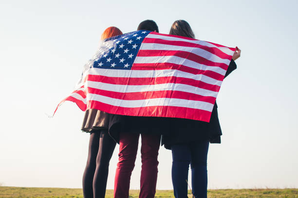 istock Group of three people with american flag. 919194682