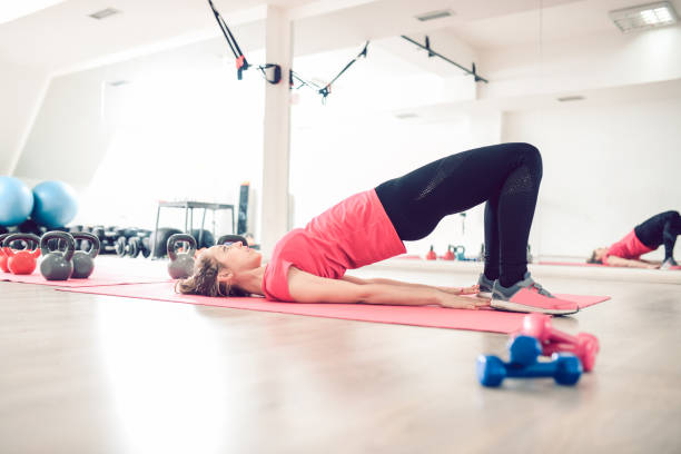 istock Young Woman Doing Yoga Backbend Abs  Exercise in Gym 919194902