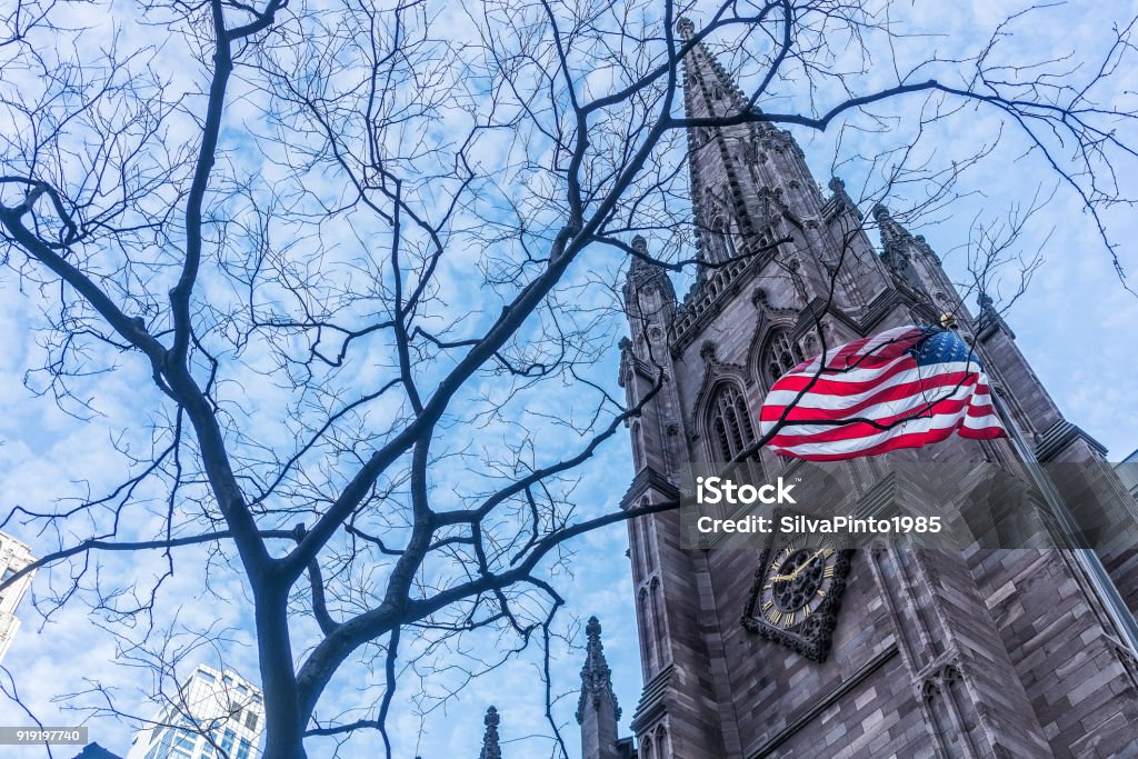 American flag with buildings behind. American Flag Stock Photo
