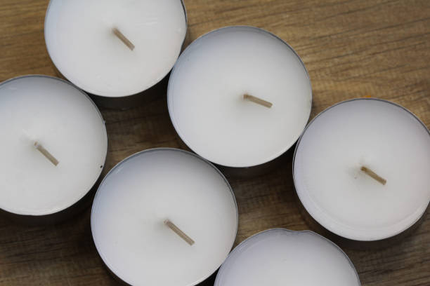istock six tea lights on wooden background 919198230