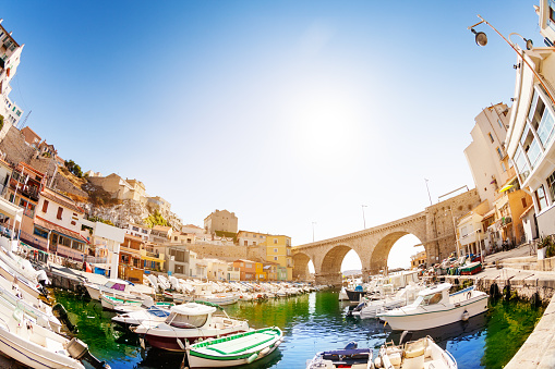 Fish-eye picture of fishing haven the Vallon des Auffes with boats and yachts at sunny day, Marseille, France