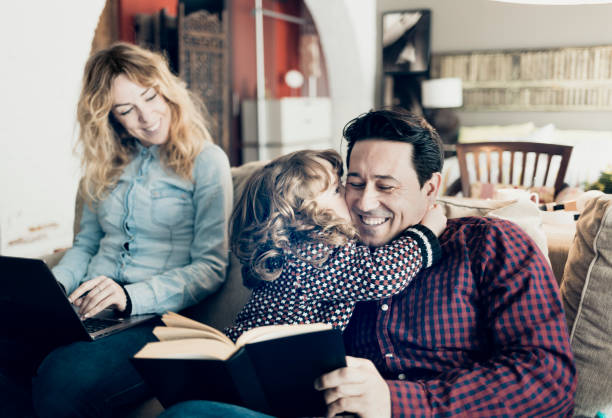 istock Child kissing father at home 919198776