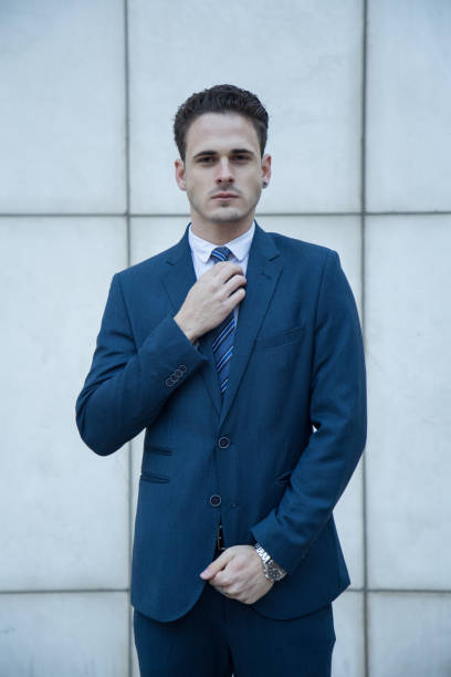 istock Young business manin suit on a white background 919198848