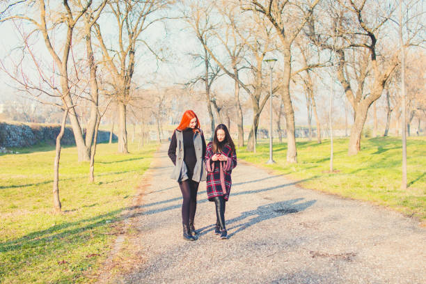 istock Two young girls walking in park. 919199210
