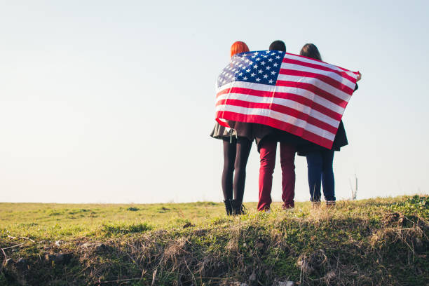 istock Group of three people with american flag. 919201654