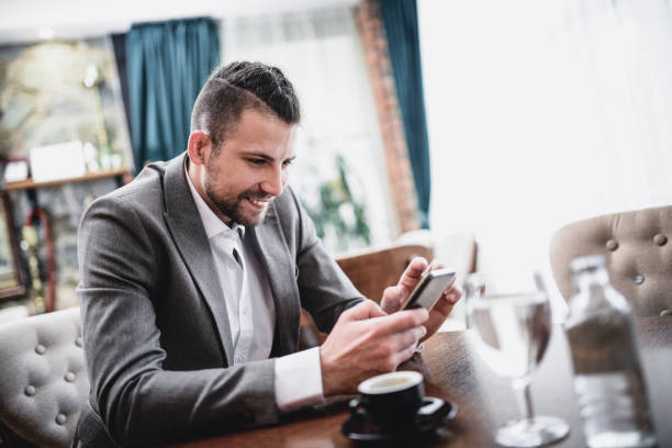 istock Smiling Business  Man With Braids Write Text Message in Restaurant 919201830