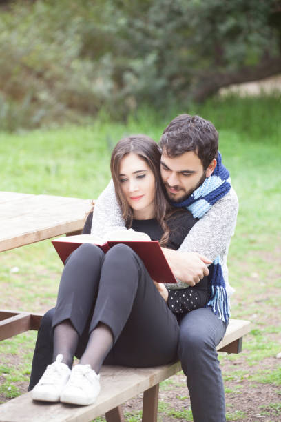 istock Young couple enjoys the outdoors with a book 919202172