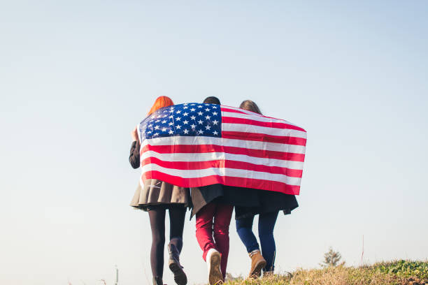 istock Group of three people with american flag. 919204296