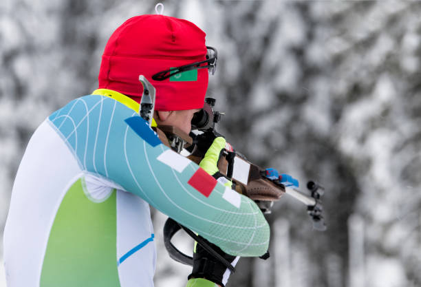 istock Side View of Female Biathlon Competitor Practicing Target Shooting in Snowstorm 919210474