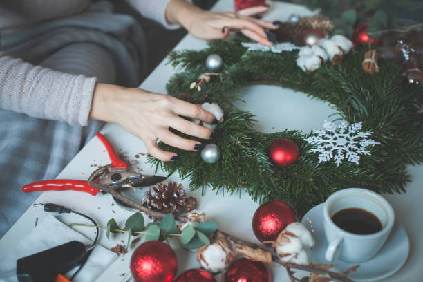 istock Florist's Workspace with Working Female Hands, Tools and Christmas Wreath 919214302
