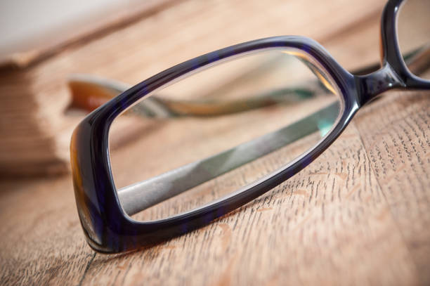 istock glasses on ancient book open on wooden table background 919223600