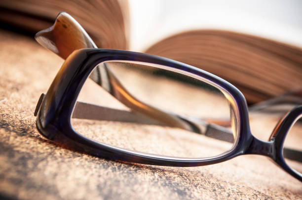 istock glasses on ancient book open on wooden table background 919223602