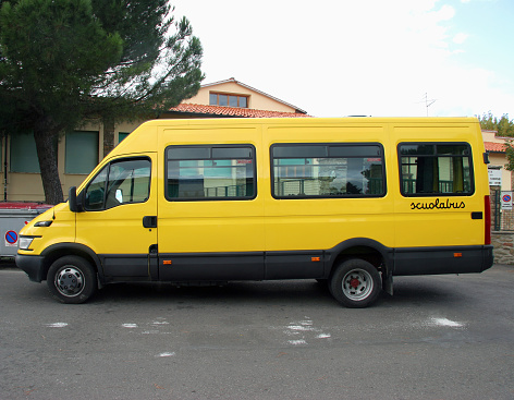 School bus parked in front of school building.