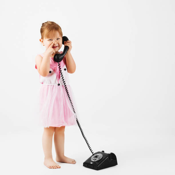 istock little kid with retro phone against a white background 919244366
