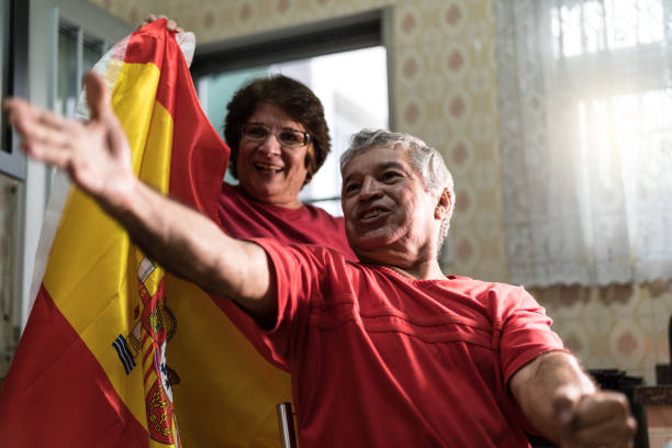 istock Spanish senior couple fan watching soccer game at home 919256848
