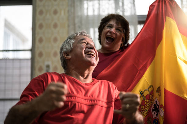 istock Spanish senior couple fan watching soccer game at home 919256854