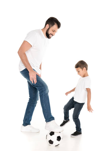 istock father and son playing soccer 919267250