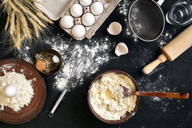 istock Pasta cooking ingredients on black kitchen table. Top view with space for your text 919277850