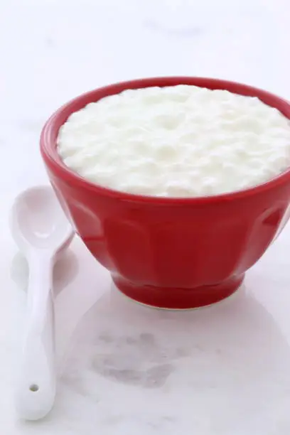 Delicious, nutritious and healthy fresh cottage cheese on vintage carrara marble setting.