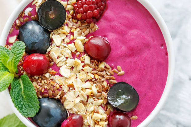 istock Red smoothie bowl with beets and black grapes. 919291560