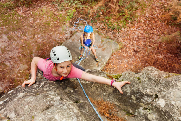 istock Girl training rock climbing in forest area 919294472