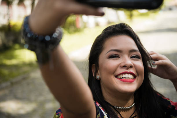 istock Happy young woman taking selfies 919309706