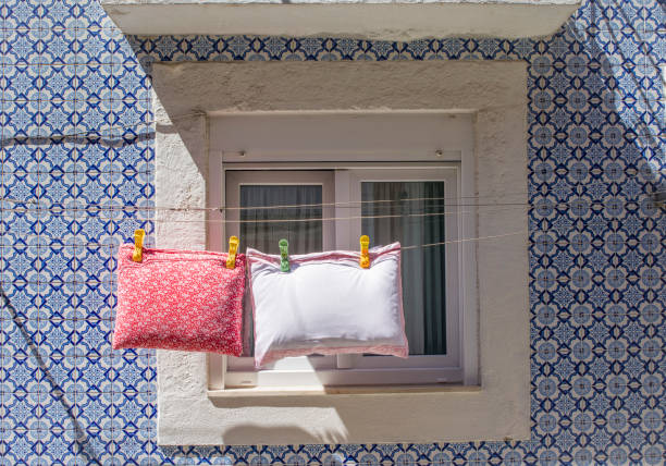 The pillows are dried on a rope on a street of Lisbon, Portugal
